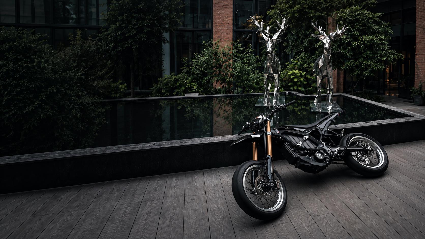 The black ZEVRO build leaning low in a dark courtyard, silver wheels and gold forks
